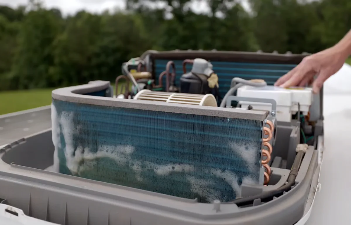 Post lake-effect storm rooftop AC capacitor swap and shroud bolt-down at a Lake Okeechobee rim-side campground