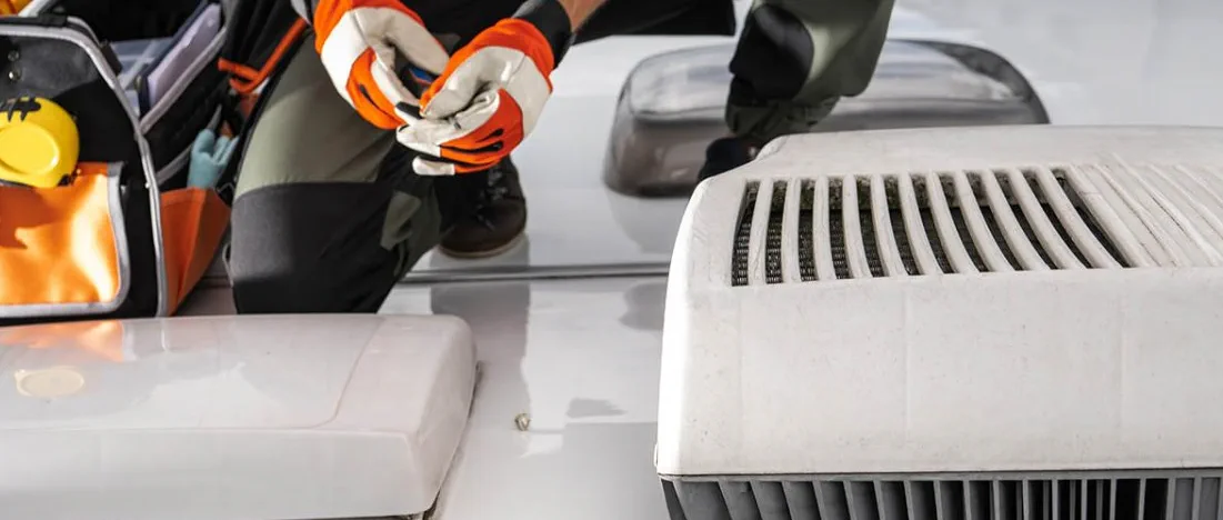 Rooftop AC capacitor swap on a Kendall Town and Country fifth wheel after summer convective storm