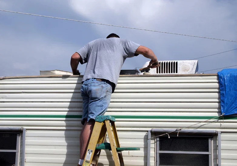 Lap-sealant top-up before May storm season on a rim canal coach